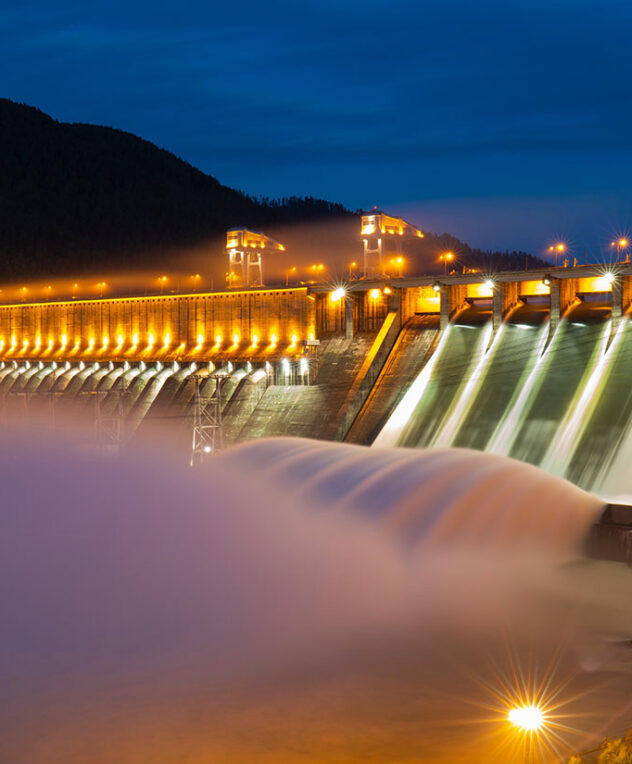 A waterfall at a dam at night time
