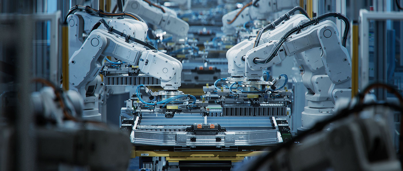 A group of robotic arms working at a factory