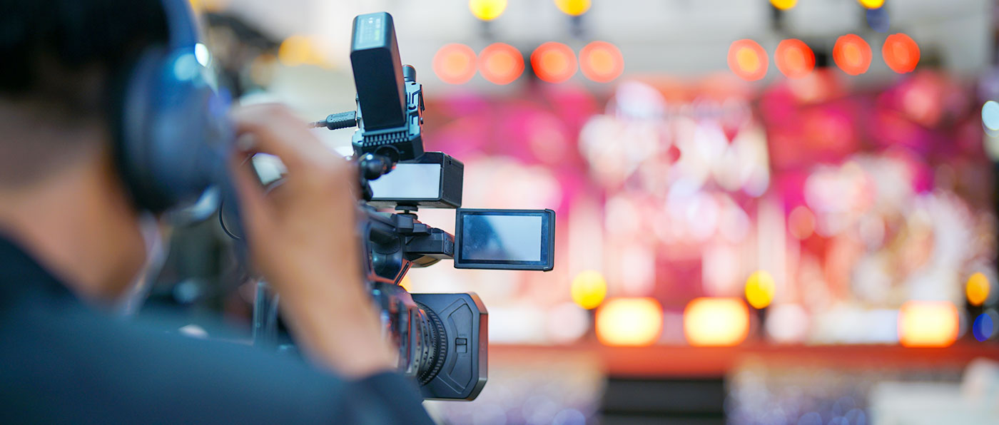 A camera operating filming a concert