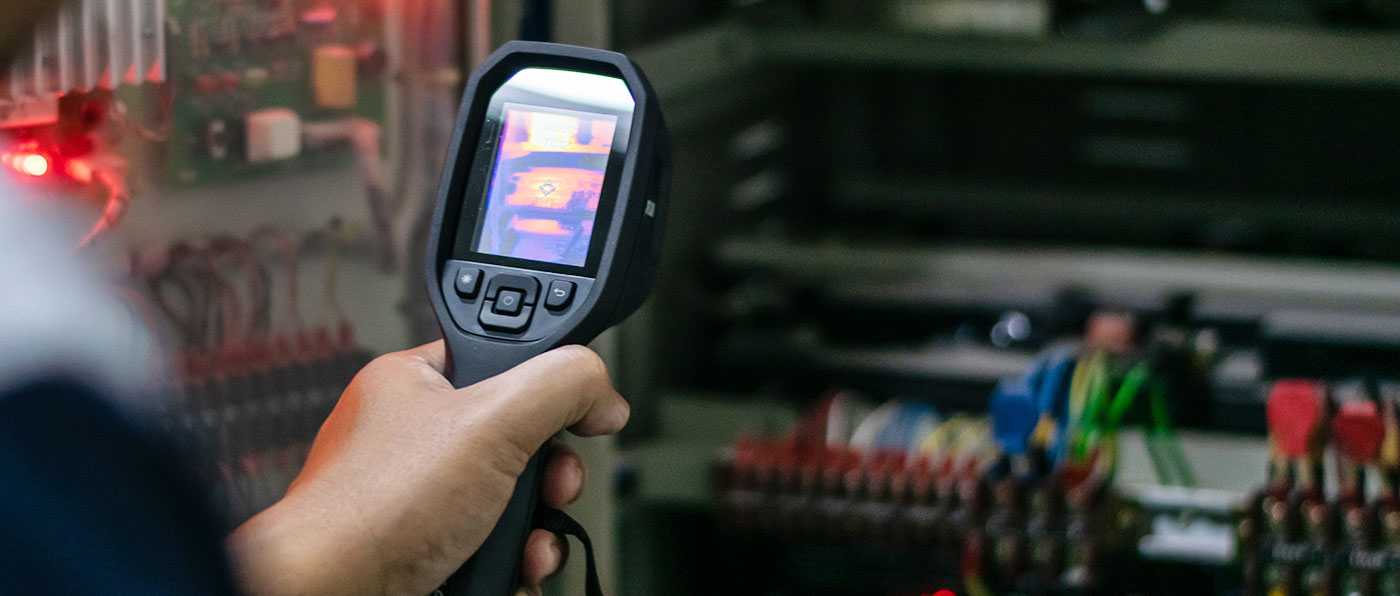 A guy holding an infrared camera