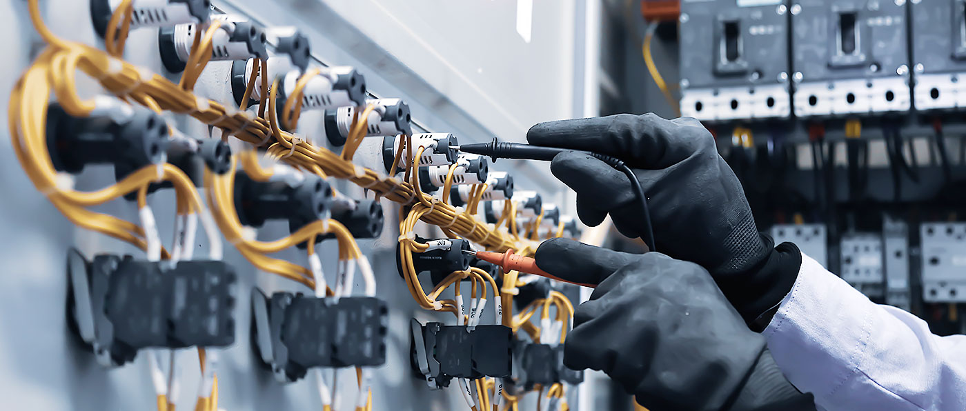 A person using a tester to connect wires